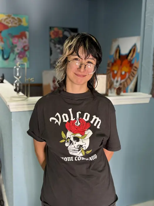 Andrea, tattoo apprentice at Blind Fox Tattoo in Amarillo, TX, standing in the studio