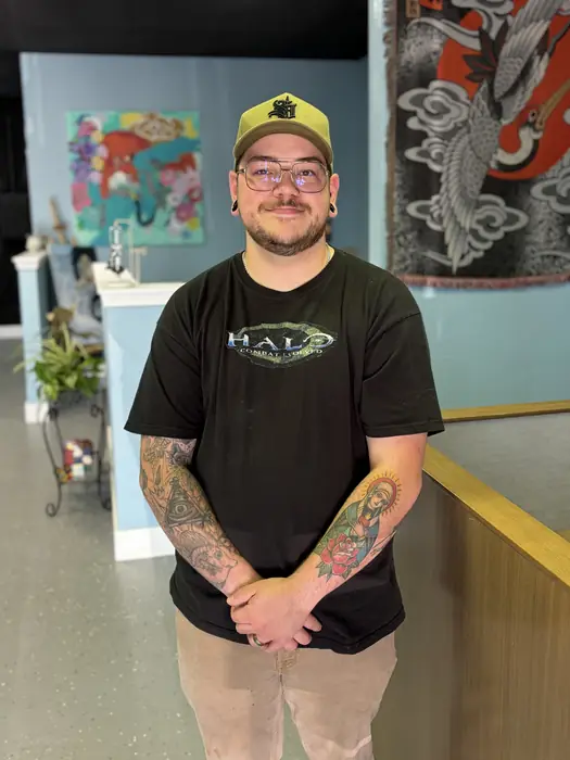 Braydon, owner and tattoo artist at Blind Fox Tattoo in Amarillo, TX, standing in the studio