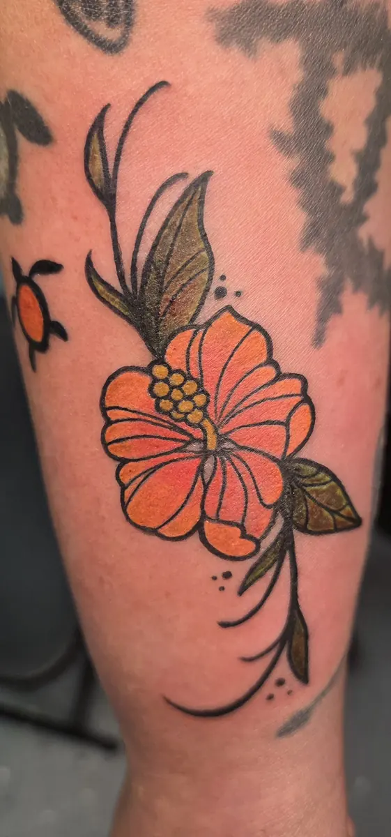 Coral hibiscus flower tattoo with soft shading on an arm