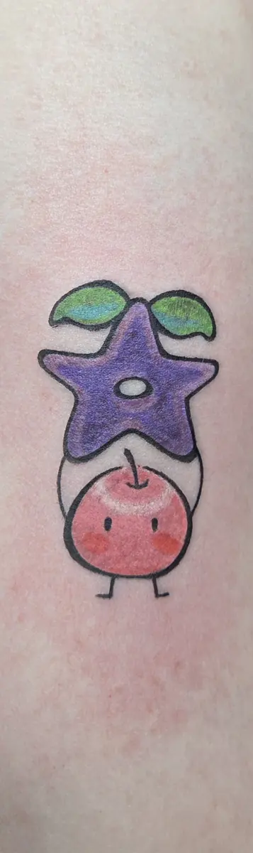 Small color cartoon character tattoo with a purple star on an arm