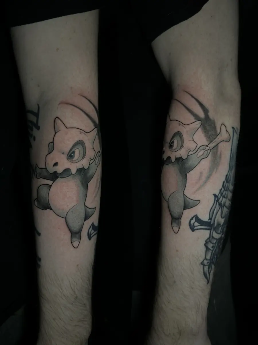 Black and grey tattoo of a video-game character on a calf, shown from two angles