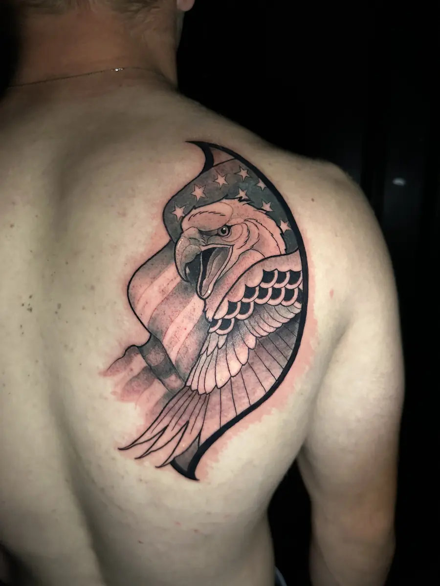 Black and grey eagle tattoo with a folded wing across a shoulder blade, tattooed at Blind Fox Tattoo in Amarillo, TX