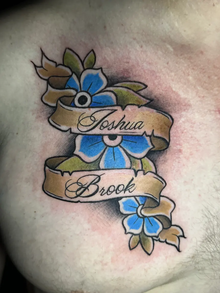 Neo-traditional chest tattoo with two name banners and blue flowers