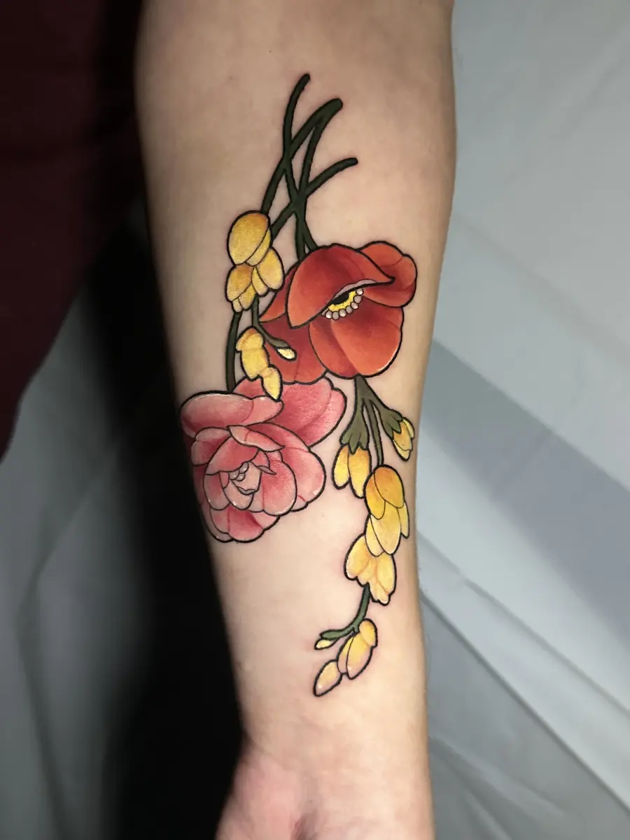 Neo-traditional poppy and rose tattoo running down a forearm in red and yellow