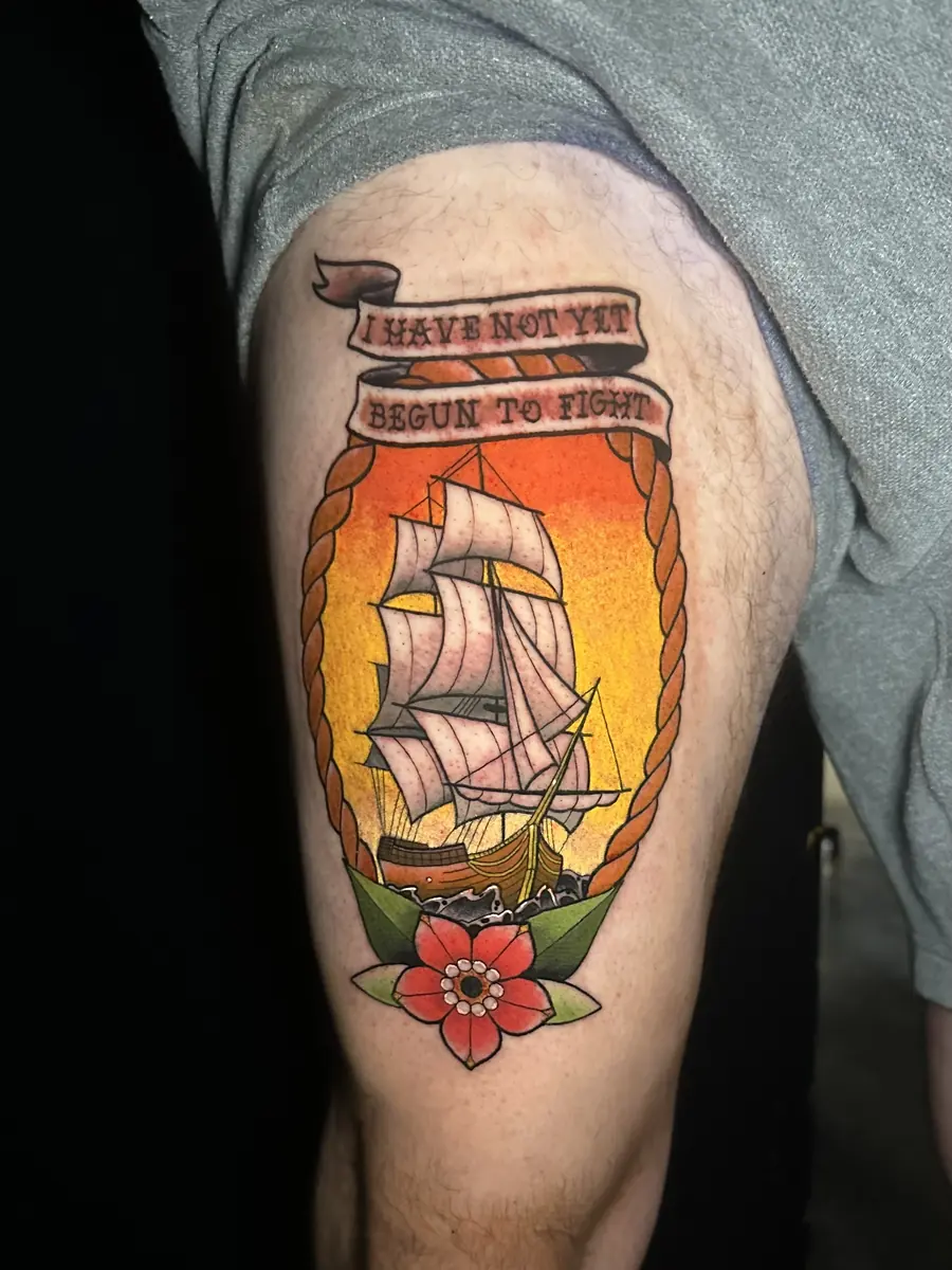 Traditional tattoo of a tall ship inside a bottle with a lettered banner above it